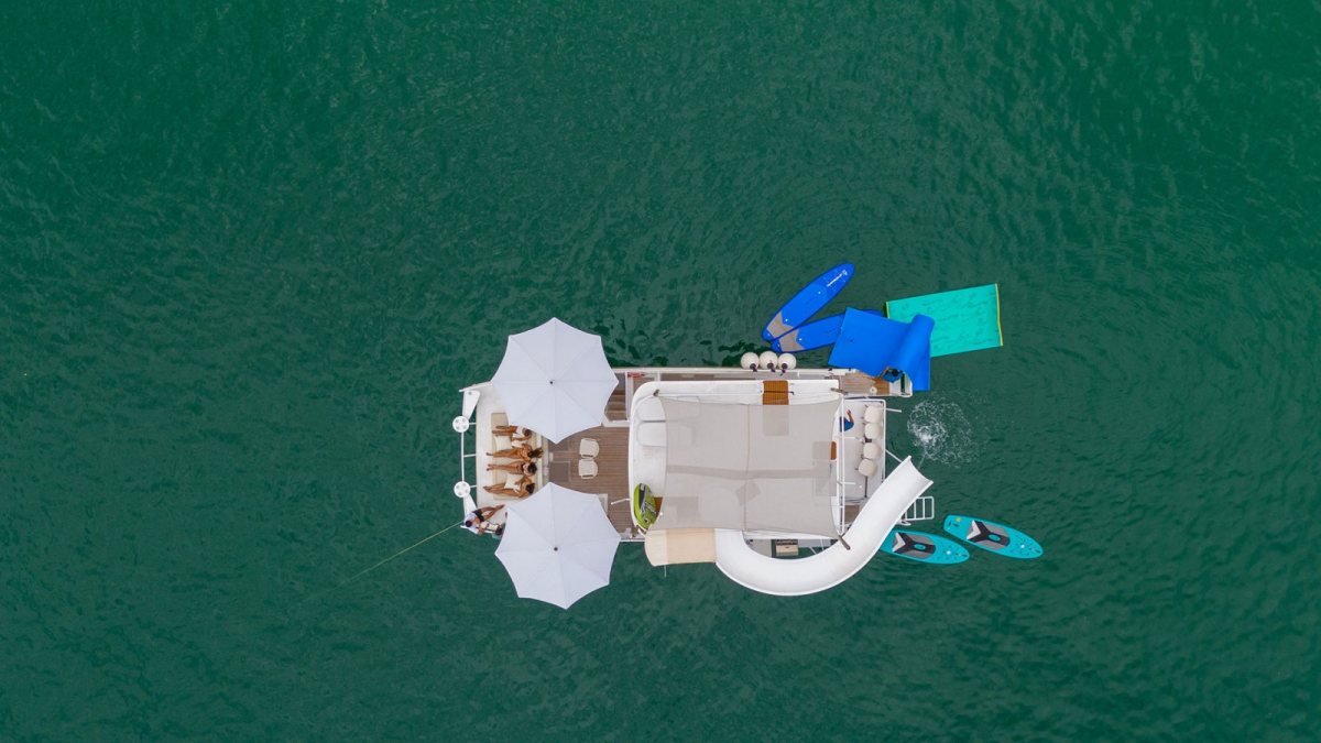 Aerial view of the Custom 45 party catamaran with waterslide and paddleboards, a party yacht charter in Puerto Vallarta